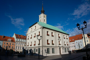 Obraz premium Former Town Hall (Ratusz) - historic building located in center of Market Square (Rynek). Tower with four-faced clock topped with spire. Gliwice, Poland.