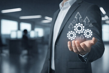 Businessman hand holding gears mechanism with arrows directed upwards showing operational efficiency and teamwork optimization