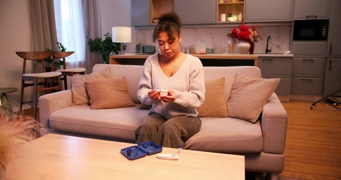 Diabetic woman measuring her blood sugar level with a glucometer