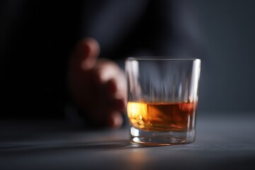 Alcohol refusal concept, man pushing away whisky glass choosing sobriety