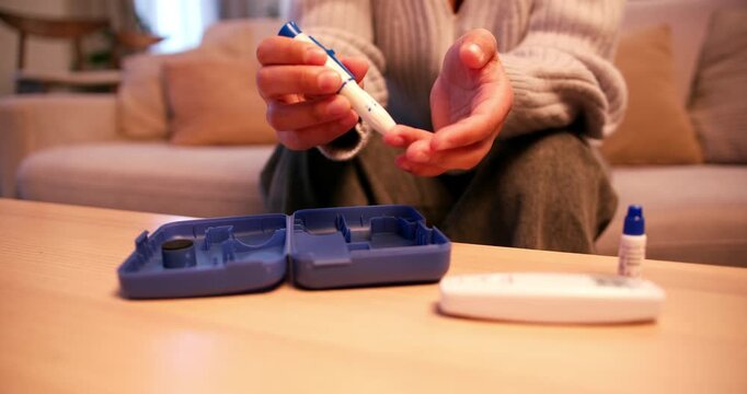 Diabetic person performing blood sugar level test at home