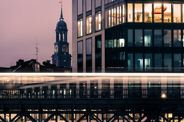 Long exposure night shot of the metro crossing in front of the famous St Michaelis Church in Hamburg