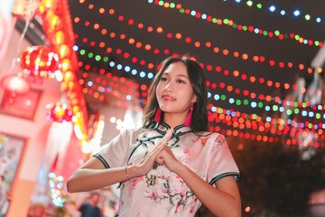 Celebratory Girl in Traditional Dress Among Colorful Festive Lights