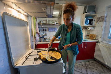 Woman flipping omelette in pan © Xalanx