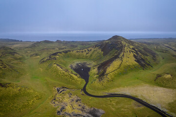 drone view of a camper van parked inside the caldera of the Holaholar Crater on the Snaefellsnes Peninsula