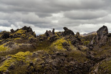 view of bizarre lava rock formations covered in lichen and moss in the Landmannalaugar Region of central Iceland