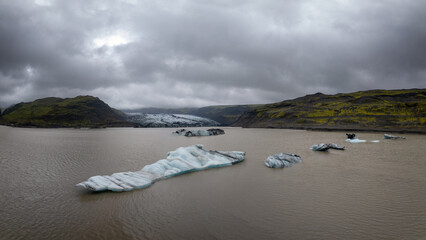 icebergs in the Solheimajokull glacier lagoon with the Myrdalsjokull Glacier inthe background