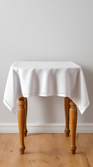 Simple wooden table white tablecloth minimal interior light wall wooden floor home decor dining furniture clean textile table leg natural wood finish Simple wooden table with white tablecloth