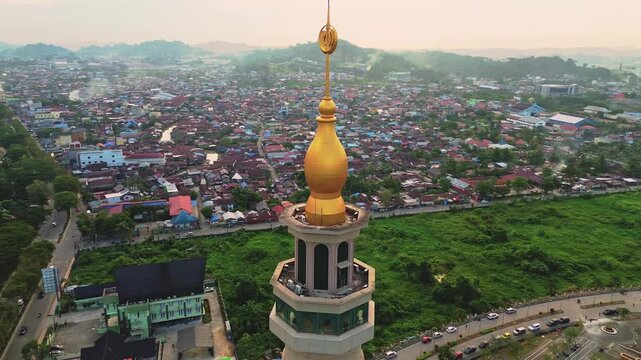 a 4k footage aerial view of islamic center or baitul muttaqien mosque in samarinda with sunset sky