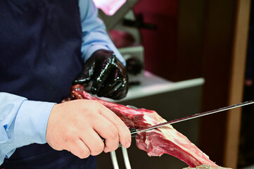 Man Slicing Spanish Jamon with Knife