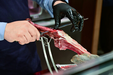 Man Slicing Spanish Jamon with Knife