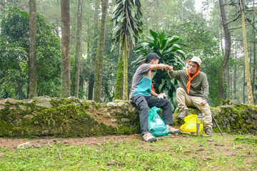 Adventurous Friends Share Fist Bump Break During Scenic Forest Hike