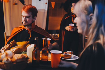 Friends enjoying a Halloween party at a bar making a toast
