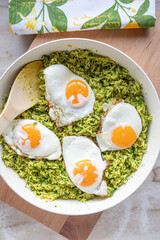 Healthy vegetarian broccoli rice pan with fried eggs sunny side up fresh and homemade cooked in a pan