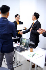 Professionals In Modern Office Setting Shaking Hands And Celebrating Success