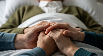 Compassionate hands holding a loved one in hospital bed