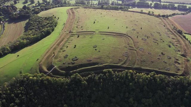 E over Hod Hill Iron Age hillfort. Blackmore Vale, Dorset. Main rampart dates from 500 BC. Once home of the Durotriges. Later Roman fort in NW corner. Video fly down in rotate counter clockwise to Rom