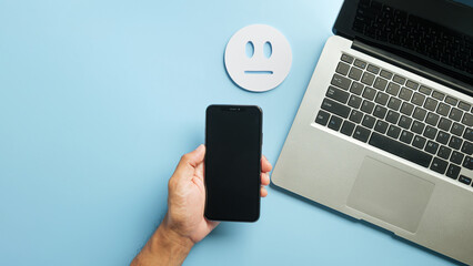 Customer satisfaction feedback online service survey with phone, laptop computer and neutral face symbol illustrates complete review experience for online interaction