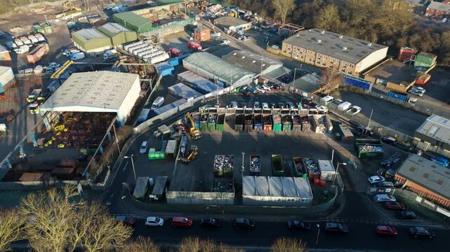 Top down aerial view of recycling centre, garbage disposal and rubbish tip, cars unloading refuse and waste in to skips, Rugby United Kingdom. 