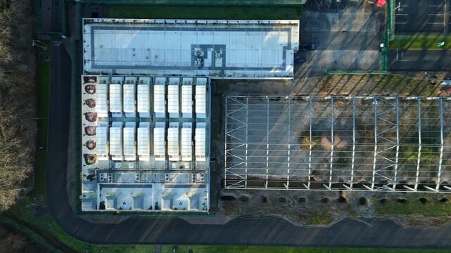 Top down aerial view of large scale data center, ATOS quantum AI computing, cloud storage and technology campus, cooling fans and turbines near Birmingham, United Kingdom