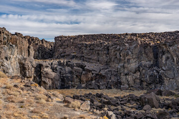 Fototapeta premium Volcanic rock, Basalt flows. Fossil Falls Trail, Coso Volcanic Field, Inyo County, California. Coso Range, Basin and Range Province.