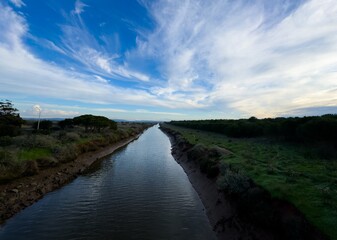 Obraz premium Picturesque landscape with trees, river and sky