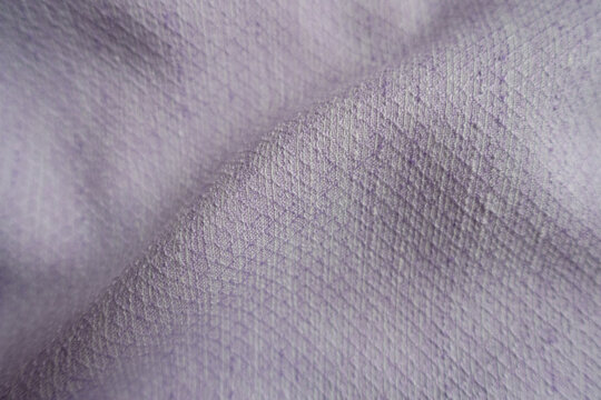 Soft fold on light violet textured viscose pique fabric