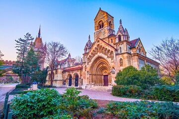 Jak Chapel in lush greenry of Vajdahunyad Castle's courtyard, Budapest, Hungary © efesenko