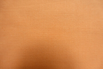 Fototapeta premium Macro of unprinted simple muted orange fabric