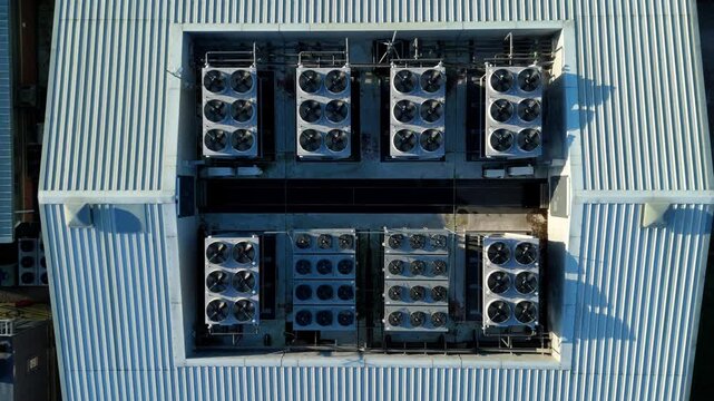 Top down aerial drone view of critical data center infrastructure with HVAC cooling fans and rooftop units supporting quantum computing cloud storage in Redditch UK