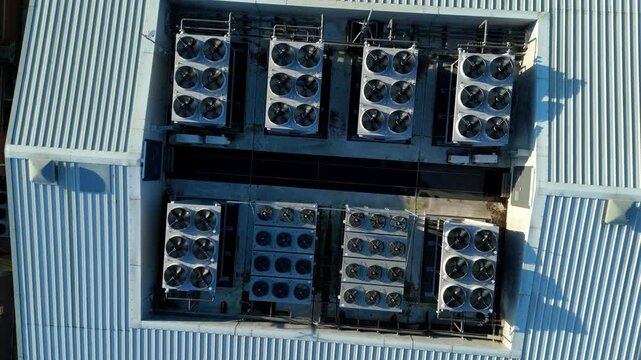Close up aerial drone view of HVAC air conditioning units and cooling fans turbines on Data center roof, Quantum computing and cloud storage IT critical infrastructure in Redditch, United Kingdom