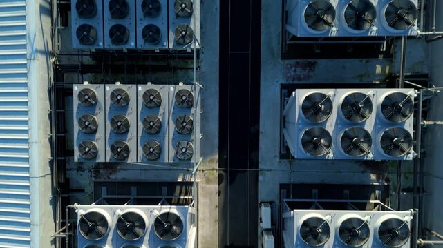 Close up aerial drone view of HVAC air conditioning units and cooling fans turbines on Data center roof, Quantum computing and cloud storage IT critical infrastructure in Redditch, United Kingdom