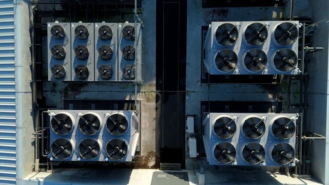 Close up aerial drone view of HVAC air conditioning units and cooling fans turbines on Data center roof, Quantum computing and cloud storage IT critical infrastructure in Redditch, United Kingdom