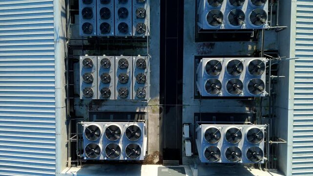 Close up aerial drone view of HVAC air conditioning units and cooling fans turbines on Data center roof, Quantum computing and cloud storage IT critical infrastructure in Redditch, United Kingdom