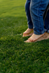 Child Standing on Parent&rsquo;s Feet on Green Grass