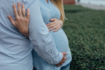 Expecting Couple Embracing Outdoors, Close-Up