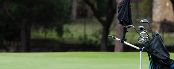 Bag of golf clubs on the golf course.