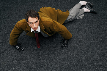 Stylish man striking a dramatic pose in a modern setting during an evening event