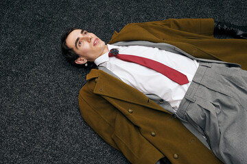 Stylish man dressed elegantly on the floor, showcasing modern fashion trends and confidence