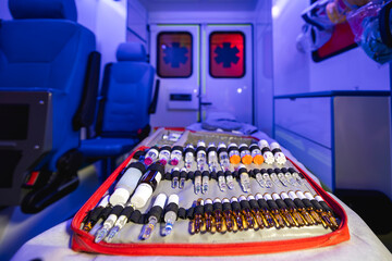 Close-up of ampoules with medication in ambulance car of emergency medical service.