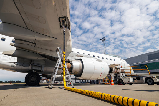 Refueling of airplane at airport. Ground service before flight.