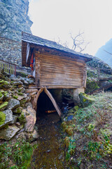 Landscape of the Almaj Valley in Romania, with the watermills of Rudăria and the mountain river.