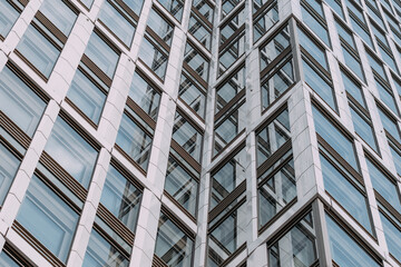 Modern office building architecture presenting corporate facade with abstract geometry pattern in glass and clean professional business design