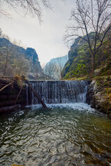 Landscape of the Almaj Valley in Romania, with the watermills of Rudăria and the mountain river.