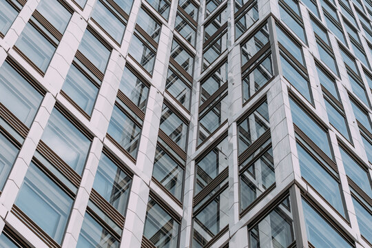 Modern office building architecture presenting corporate facade with abstract geometry pattern in glass and clean professional business design