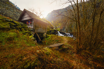 Landscape of the Almaj Valley in Romania, with the watermills of Rudăria and the mountain river.