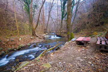Landscape of the Almaj Valley in Romania, with the watermills of Rudăria and the mountain river.