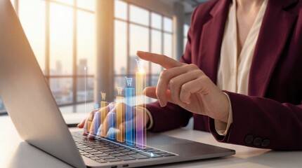 Womans hand interacting with a glowing bar graph showing shopping cart icons, symbolizing ecommerce growth and online sales analysis on a laptop