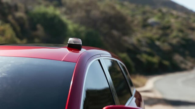 Close-up of a red car with a V16 beacon flashing on its roof, stopped on a mountain road during the day. Road safety concept and new regulations for V16 emergency signaling devices in realistic 3D