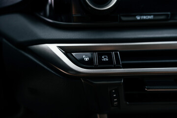 Fototapeta premium A premium, modern brown car interior, leather steering wheel, large navigation screen, air ducts, deflectors on the car panel. Interior details.